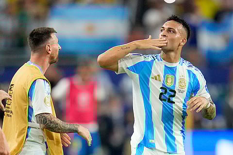 Lautaro Martínez celebrates with Lionel Messi after scoring his side's opening goal